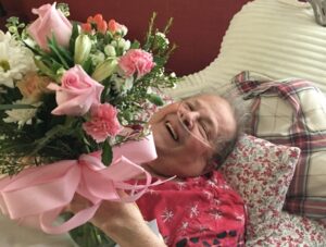 Carol receiving flowers in bed on Mother's Day